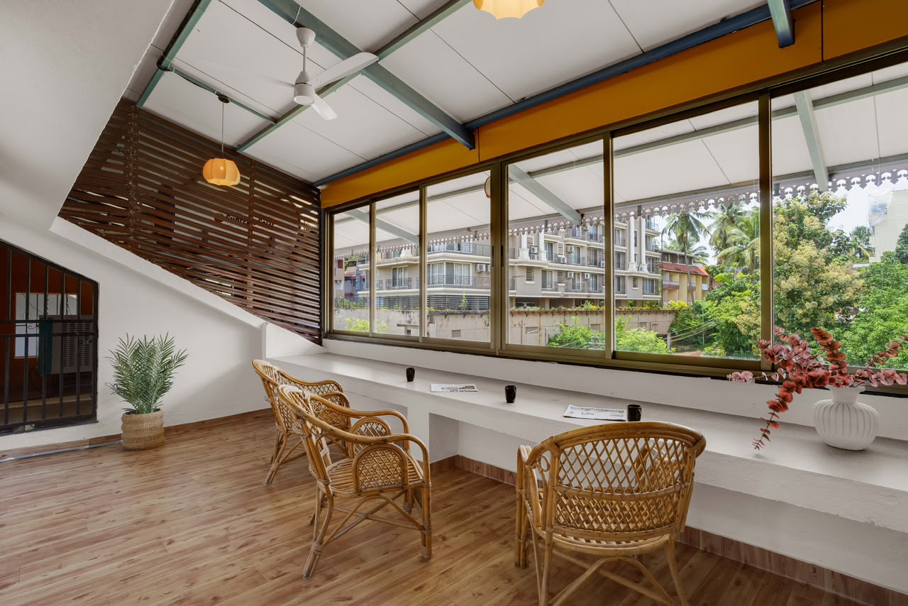 A common-area reading nook at Casa Amarilla, with rattan chairs by a window